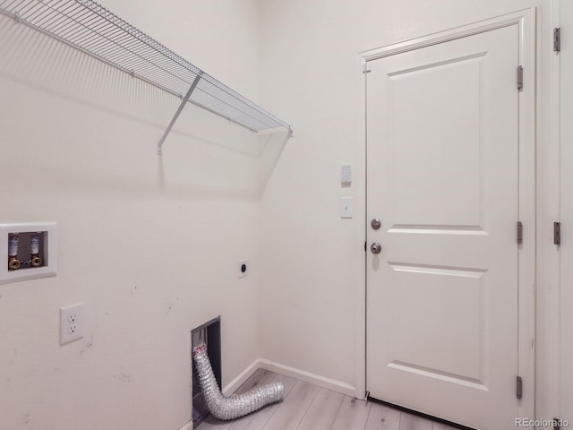 washroom featuring light hardwood / wood-style flooring and hookup for an electric dryer