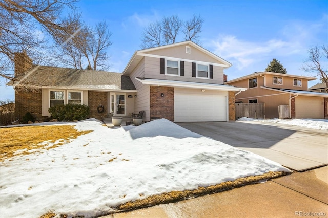 view of front facade with an attached garage, brick siding, fence, concrete driveway, and a chimney