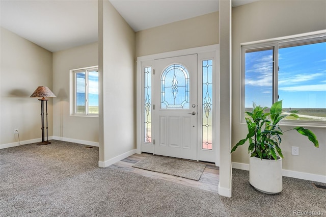 carpeted entryway with baseboards