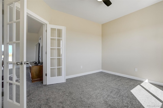 carpeted empty room featuring baseboards, french doors, and a ceiling fan