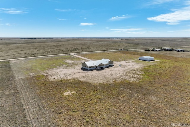 birds eye view of property with a rural view