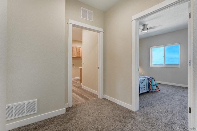 corridor with light colored carpet