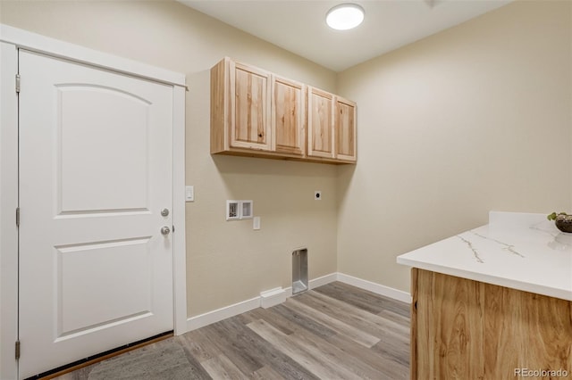 laundry room featuring cabinets, hookup for an electric dryer, light hardwood / wood-style floors, and hookup for a washing machine