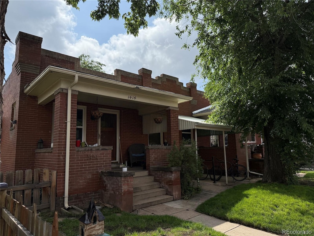 1414 S Pearl St, Denver, CO 80210 - view of front of house with brick siding, a porch, and a chimney