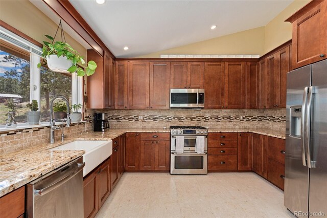 11398 Ranch Elsie Rd, Golden, CO 80403 - kitchen featuring lofted ceiling, backsplash, a sink, light stone countertops, and appliances with stainless steel finishes