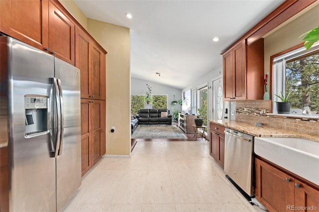 11398 Ranch Elsie Rd, Golden, CO 80403 - kitchen with tasteful backsplash, light stone counters, lofted ceiling, appliances with stainless steel finishes, and recessed lighting