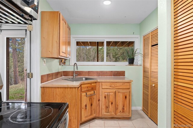 11398 Ranch Elsie Rd, Golden, CO 80403 - kitchen featuring light tile patterned flooring, electric range oven, light countertops, and a sink