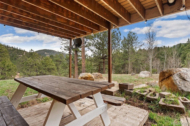 11398 Ranch Elsie Rd, Golden, CO 80403 - view of patio featuring outdoor dining area, a mountain view, and a wooded view