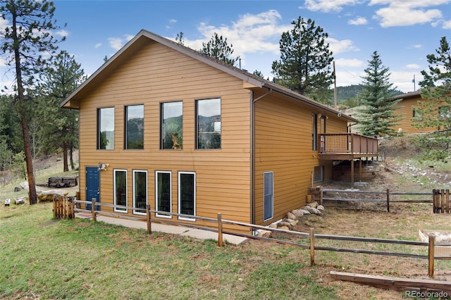 11398 Ranch Elsie Rd, Golden, CO 80403 - back of property featuring a wooden deck, a yard, and fence