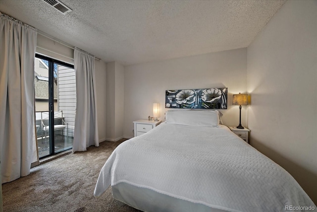 bedroom with carpet flooring and a textured ceiling