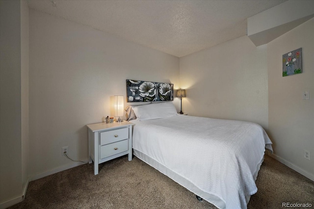 carpeted bedroom featuring baseboards and a textured ceiling