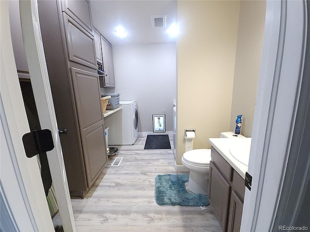 bathroom featuring visible vents, vanity, toilet, and wood finished floors