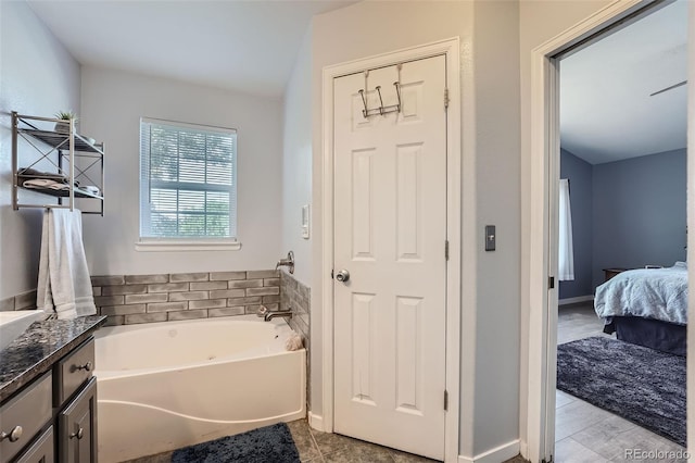 ensuite bathroom with ensuite bathroom, vanity, and a bath