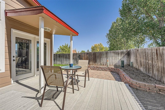 wooden deck featuring a fenced backyard and outdoor dining space