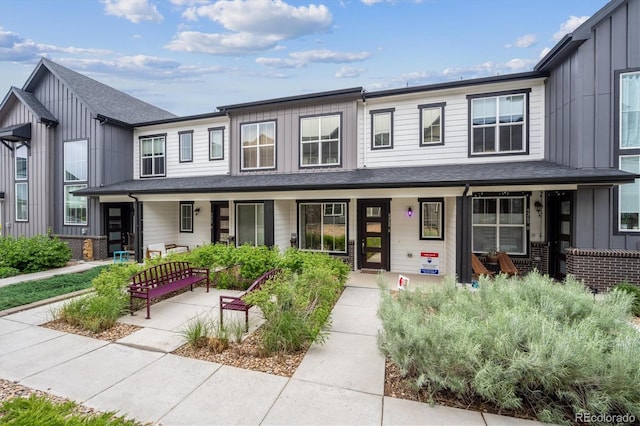 9269 Garnett St Unit C, Arvada, CO 80007 - townhome / multi-family property with a porch and board and batten siding