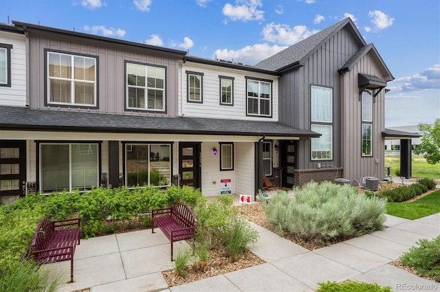 9269 Garnett St Unit C, Arvada, CO 80007 - view of front of property featuring board and batten siding, covered porch, and roof with shingles