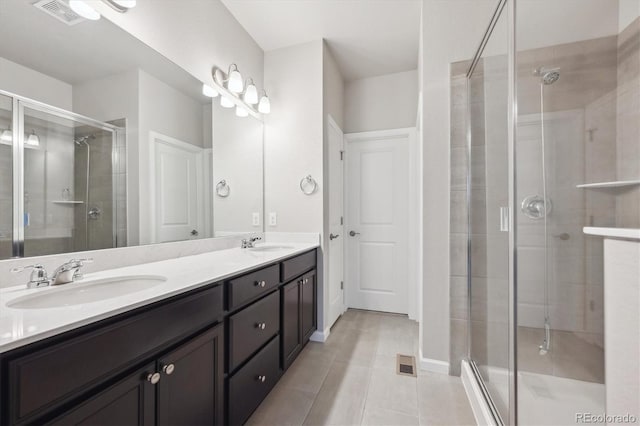 9269 Garnett St Unit C, Arvada, CO 80007 - bathroom with double vanity, a stall shower, and tile patterned flooring