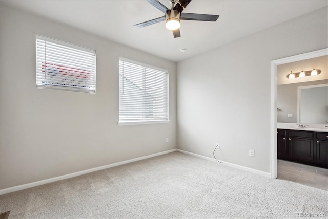 9269 Garnett St Unit C, Arvada, CO 80007 - unfurnished bedroom with light carpet, baseboards, ensuite bathroom, a sink, and ceiling fan