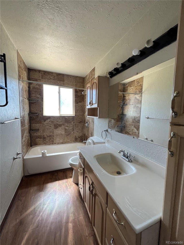 18064 E Ford Pl, Aurora, CO 80017 - full bath featuring toilet, a textured ceiling, bathtub / shower combination, vanity, and wood finished floors