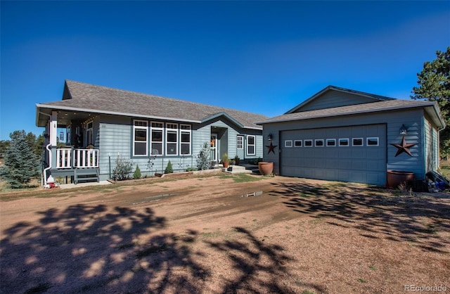 ranch-style home featuring a porch and a garage