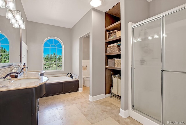 full bathroom featuring toilet, vanity, separate shower and tub, and tile patterned flooring