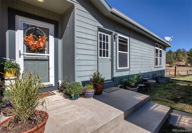 view of exterior entry with a patio area