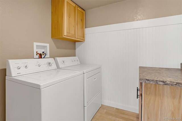 washroom with cabinets, light hardwood / wood-style flooring, and separate washer and dryer