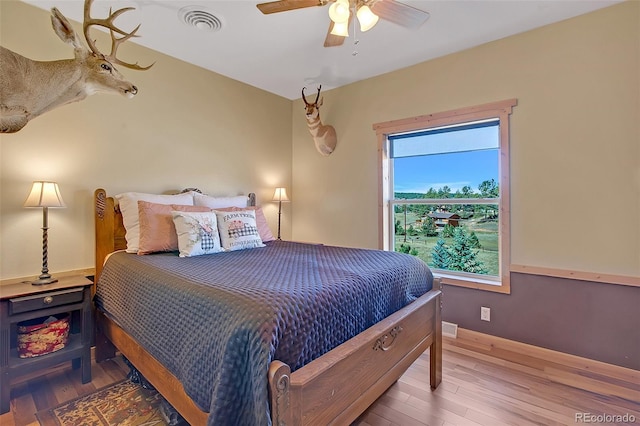 bedroom featuring hardwood / wood-style floors and ceiling fan