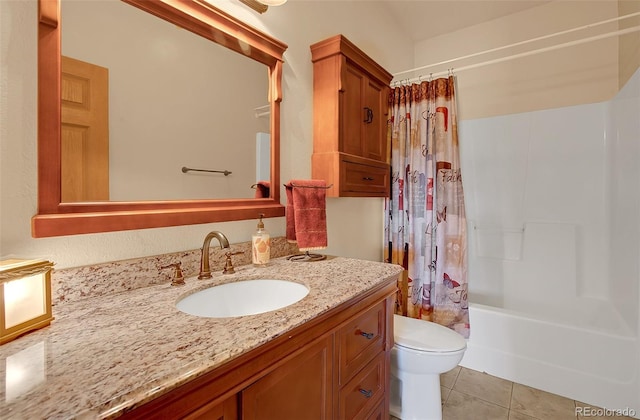 full bathroom with shower / tub combo, tile patterned flooring, vanity, and toilet