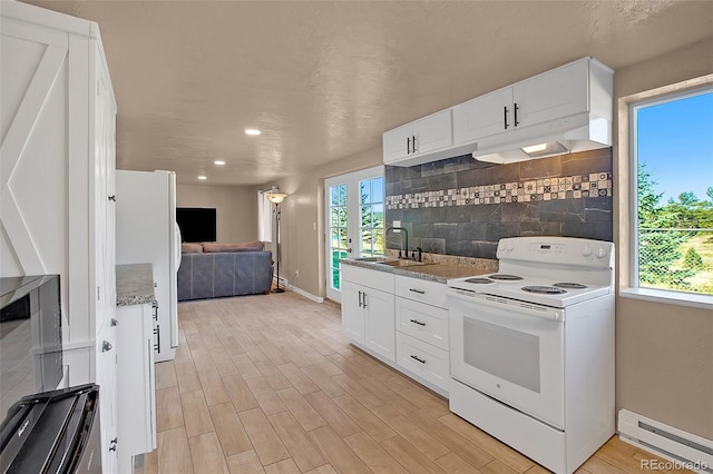 kitchen with white cabinets, white appliances, light hardwood / wood-style flooring, sink, and a baseboard heating unit