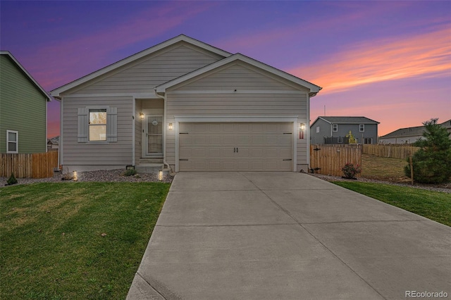 view of front of property featuring a yard and a garage