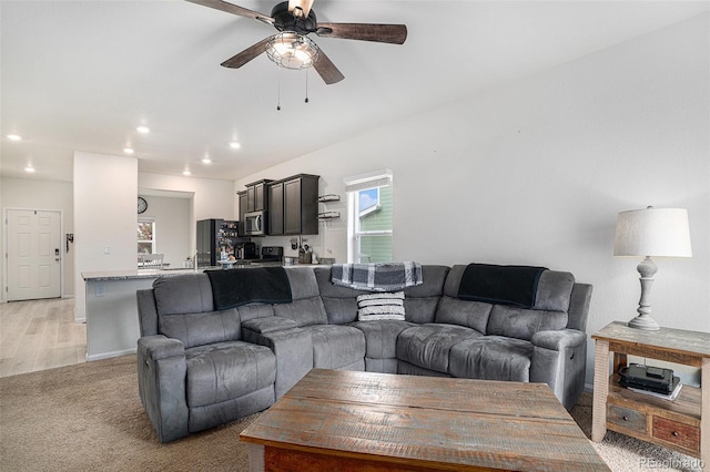 living room with ceiling fan and light wood-type flooring