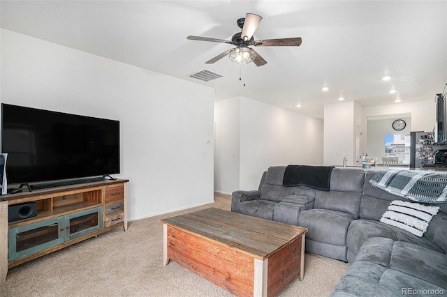 carpeted living room featuring ceiling fan