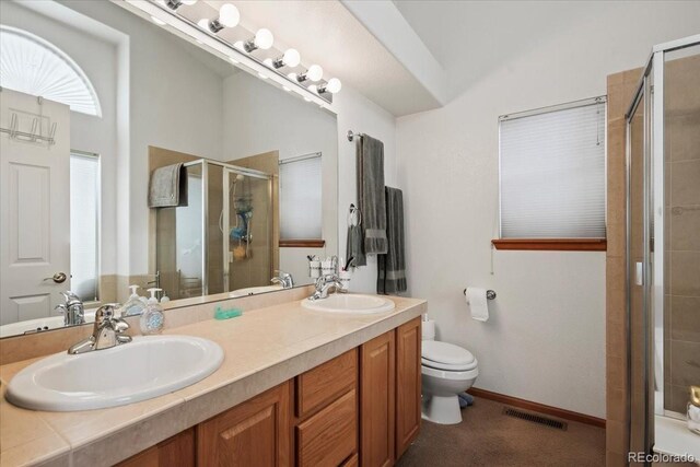 1434 Hickory Dr, Erie, CO 80516 - bathroom featuring toilet, vanity, and a shower with door