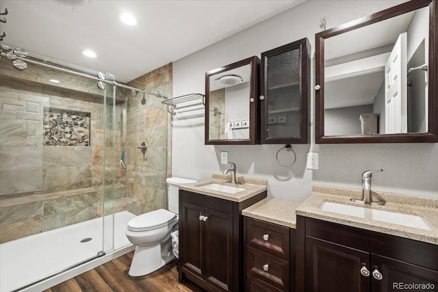1434 Hickory Dr, Erie, CO 80516 - bathroom featuring hardwood / wood-style flooring, toilet, walk in shower, and vanity