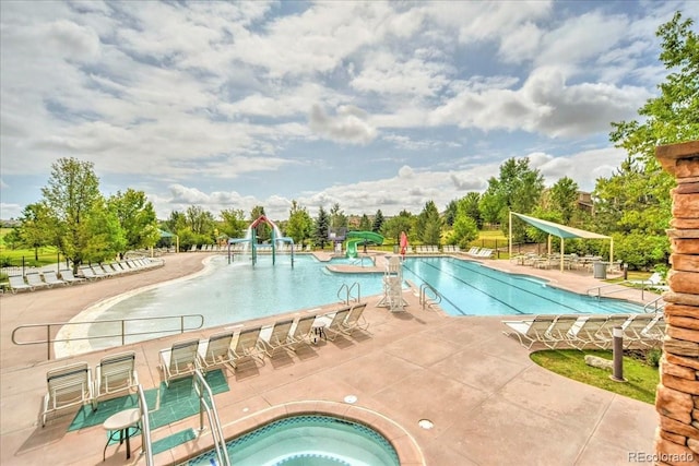 1434 Hickory Dr, Erie, CO 80516 - view of pool featuring a hot tub, a water slide, and a patio