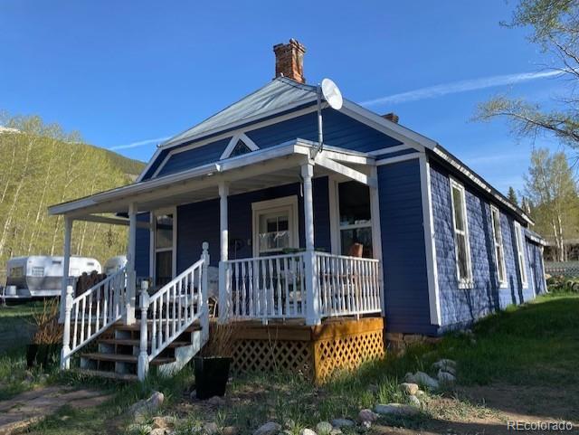 149 Lang St, Twin Lakes, CO 81251 - view of front of home with covered porch and a chimney