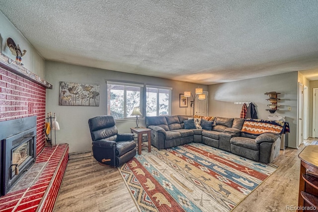 living room featuring wood-type flooring and a textured ceiling