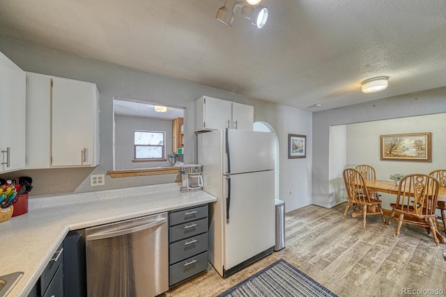 kitchen with dishwasher, white refrigerator, light hardwood / wood-style floors, and white cabinets