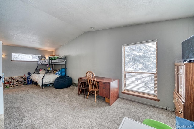 bedroom featuring a textured ceiling, light colored carpet, multiple windows, and vaulted ceiling