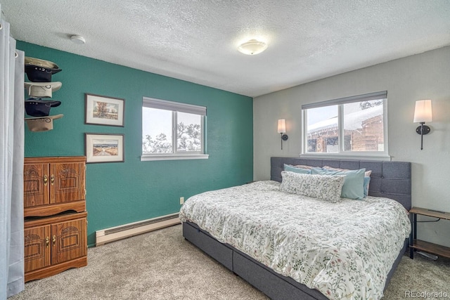 bedroom with baseboard heating, carpet flooring, and a textured ceiling