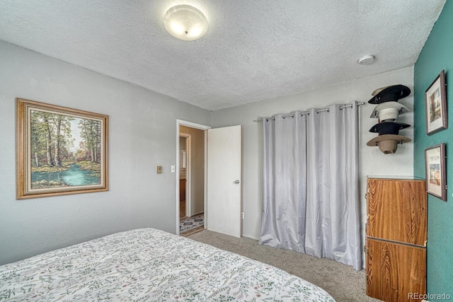 carpeted bedroom with a textured ceiling