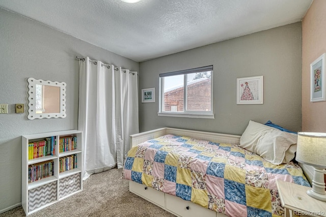 bedroom with a textured ceiling and light colored carpet