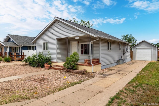436 S 4th Ave, Brighton, CO 80601 - view of front of house featuring an outdoor structure, a porch, concrete driveway, and a detached garage