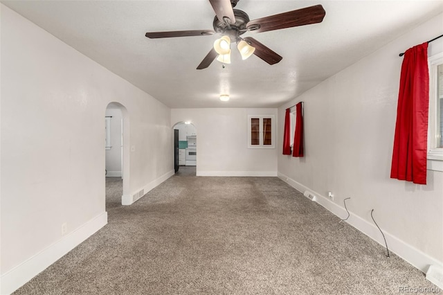 436 S 4th Ave, Brighton, CO 80601 - spare room featuring arched walkways, carpet floors, and a ceiling fan