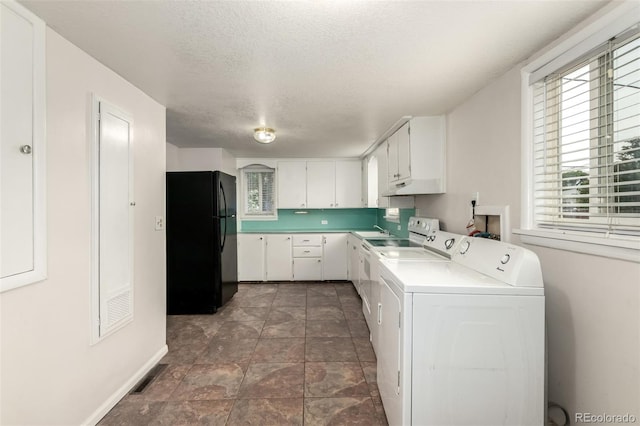 436 S 4th Ave, Brighton, CO 80601 - laundry area featuring washer and clothes dryer, a textured ceiling, and stone finish floors