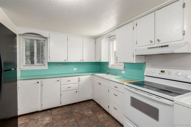 436 S 4th Ave, Brighton, CO 80601 - kitchen featuring white electric stove, under cabinet range hood, freestanding refrigerator, light countertops, and a textured ceiling