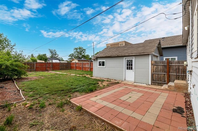 436 S 4th Ave, Brighton, CO 80601 - fenced backyard featuring a patio and an outbuilding