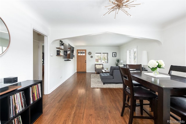 489 S Gaylord St, Denver, CO 80209 - dining room with dark wood-style floors, a chandelier, and baseboards