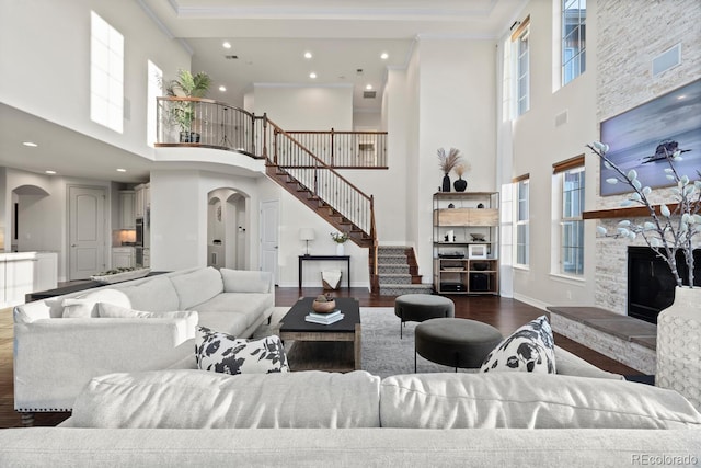 771 Braesheather Pl, Highlands Ranch, CO 80126 - living area with wood finished floors, a high ceiling, a healthy amount of sunlight, stairway, and arched walkways